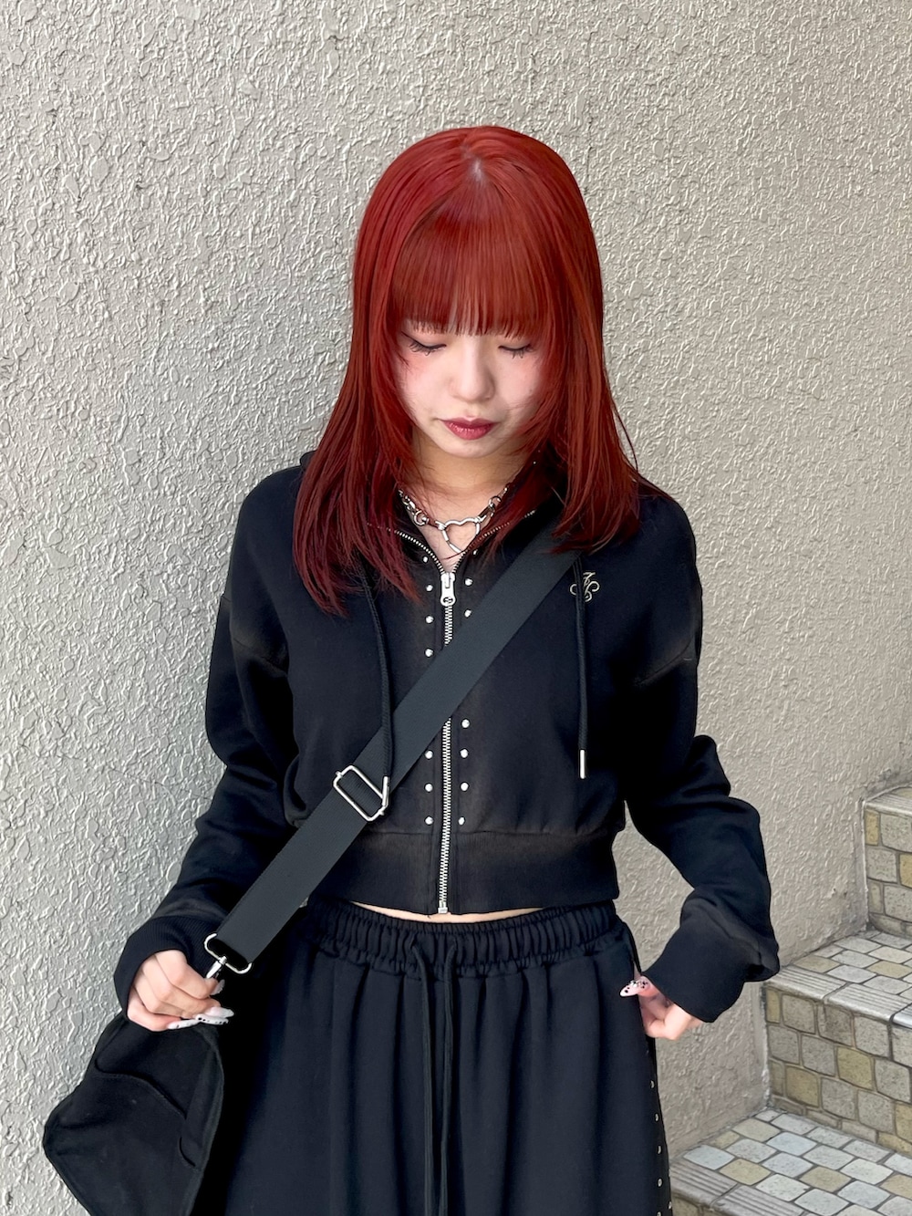 ブラック系のパーカー、ブラック系のスウェットパンツ、ブラック系のボストンバッグを着用したレディースの春コーディネートの5枚目の写真