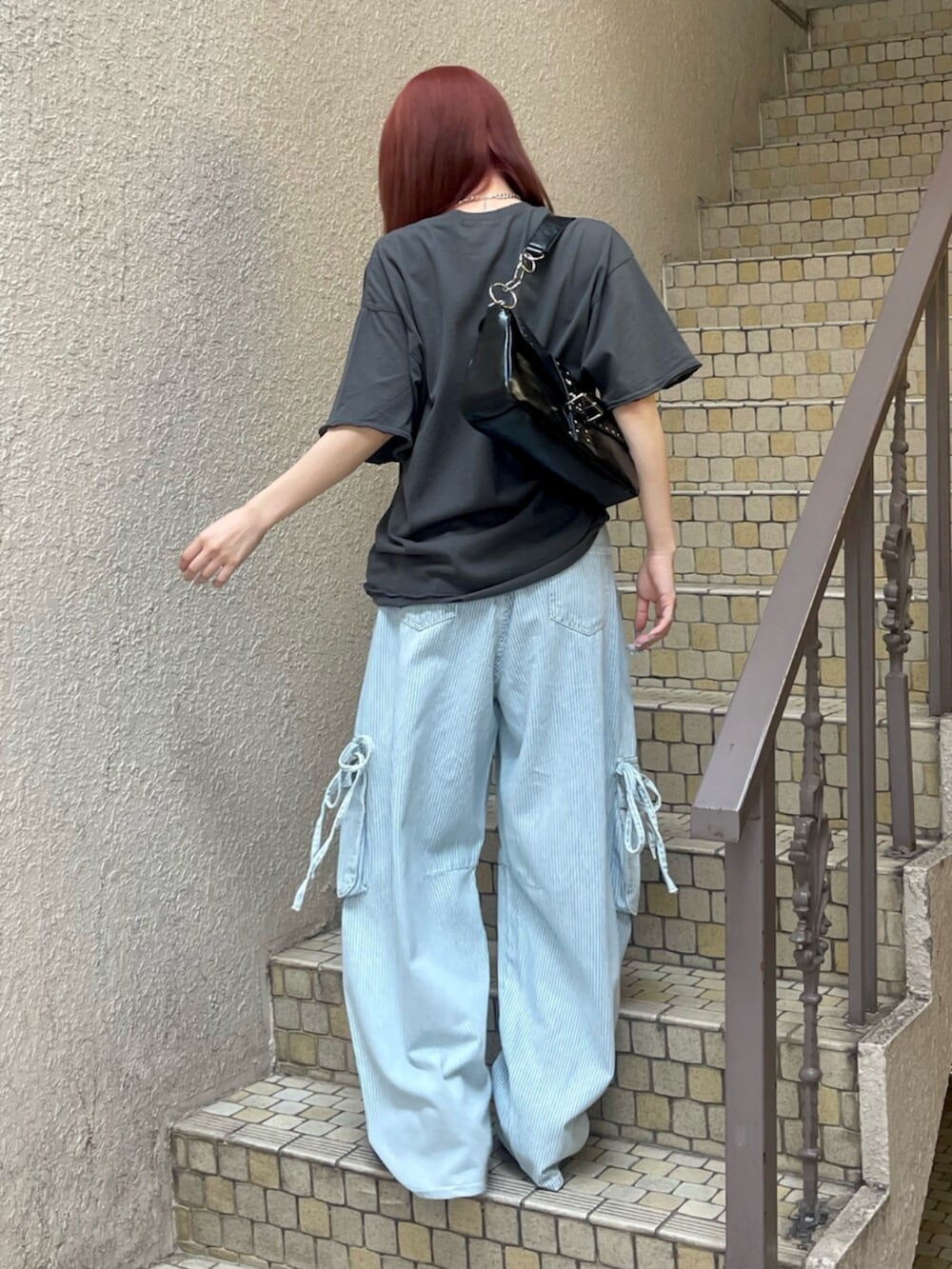 ブラック系のパンプス、ブラック系のハンドバッグ、ブラック系のTシャツ/カットソーを着用したレディースの春コーディネートの3枚目の写真