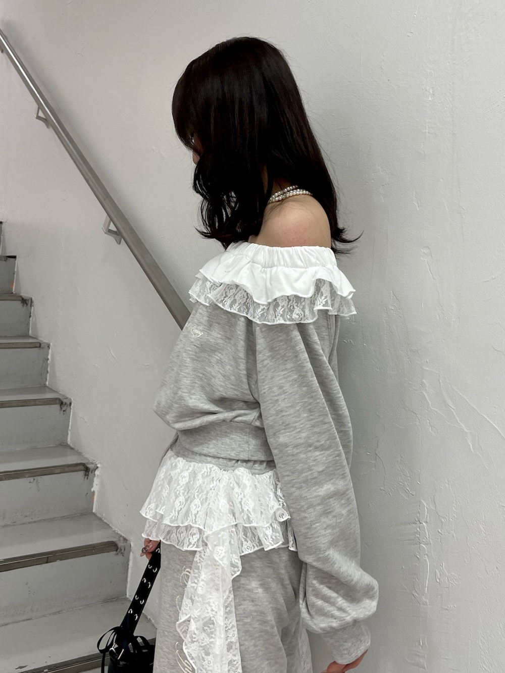 グレー系のスウェット、グレー系のスウェットパンツ、ブラック系のハンドバッグを着用したレディースの冬コーディネートの6枚目の写真