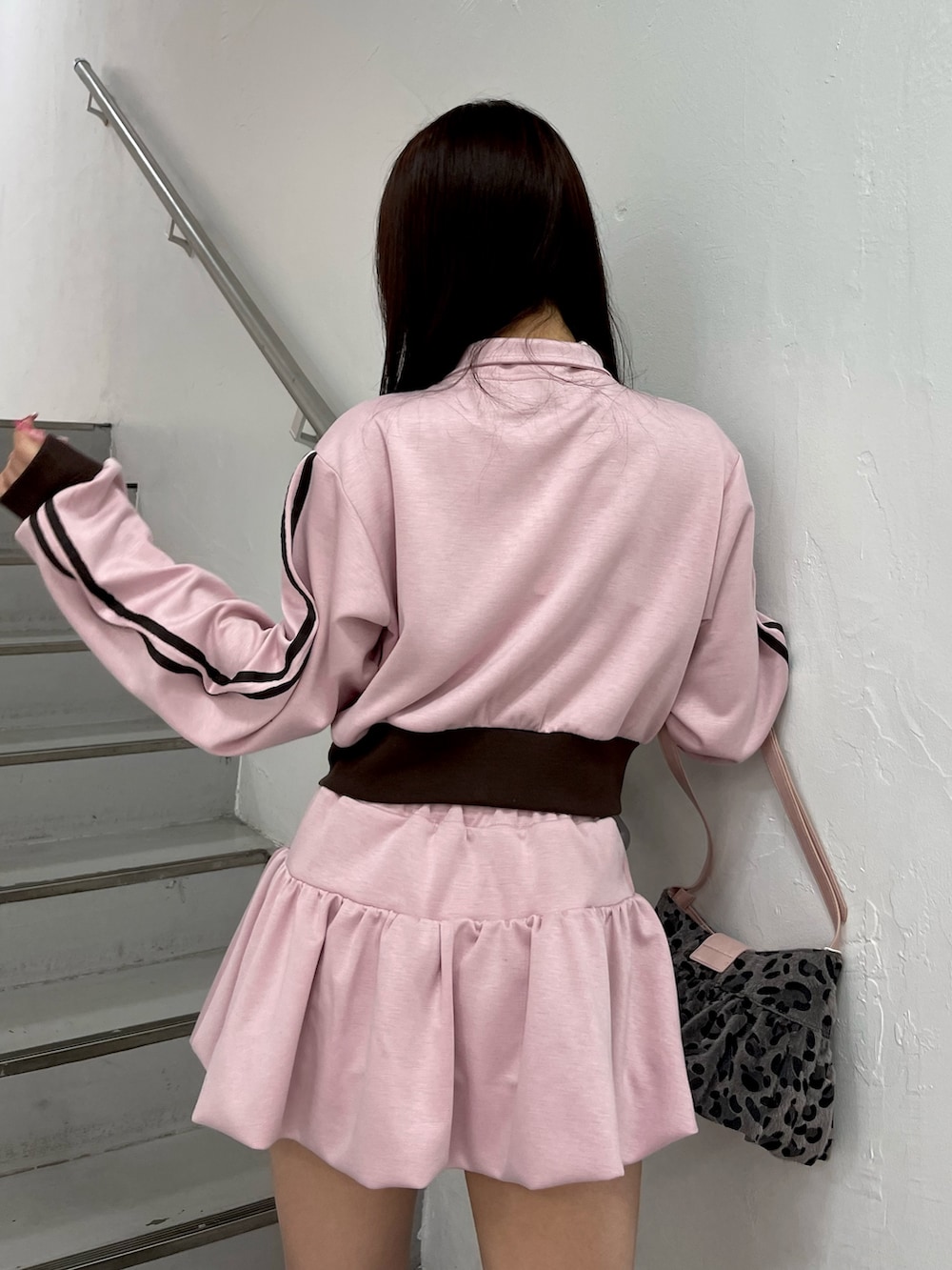 ブラック系のブーツ、ピンク系のスカート、ピンク系のジャージを着用したレディースの冬コーディネートの7枚目の写真