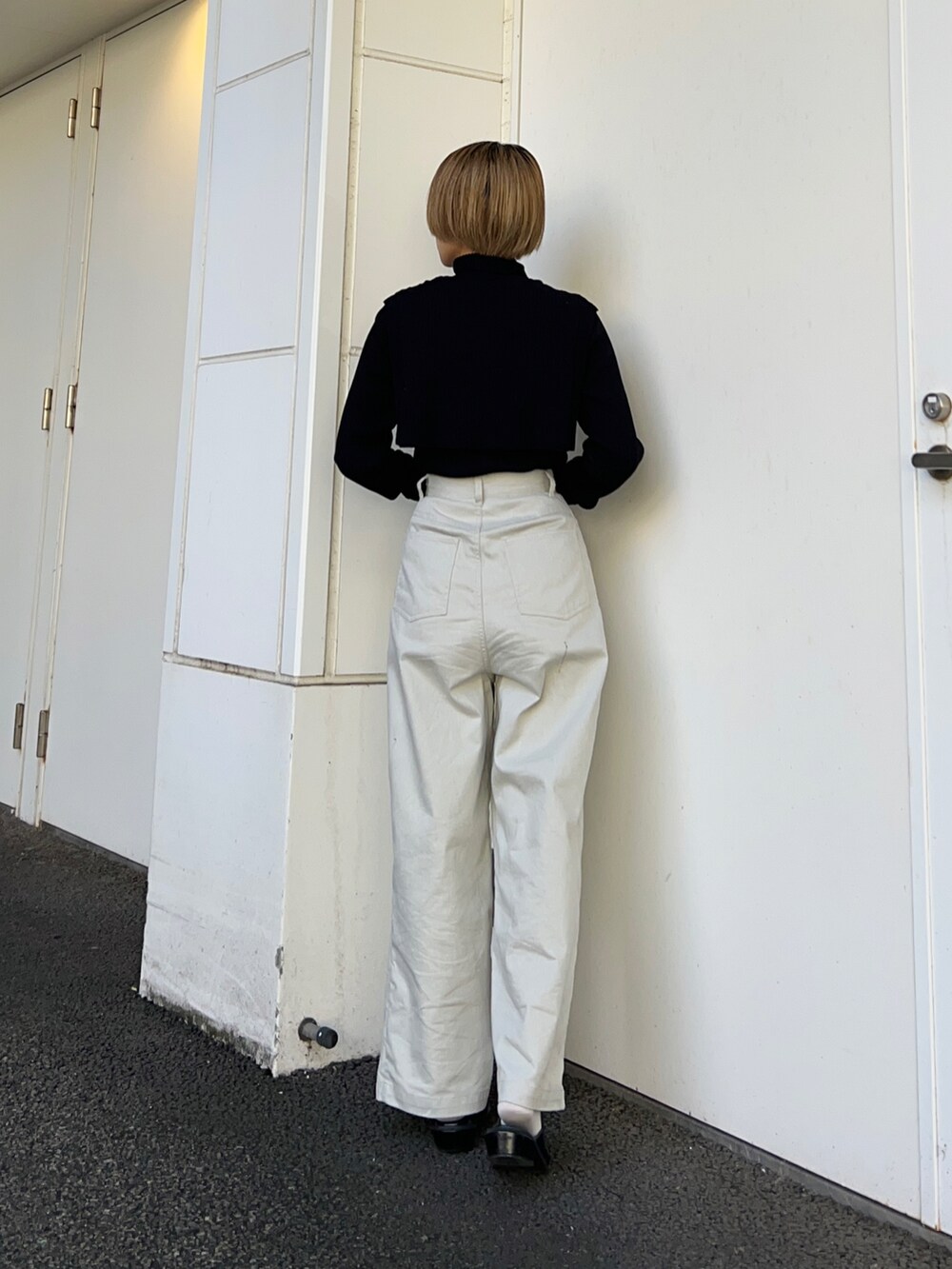 ブラック系のその他シューズ、ブラック系のニット/セーター、グレー系のその他パンツを着用したレディースの秋コーディネートの3枚目の写真