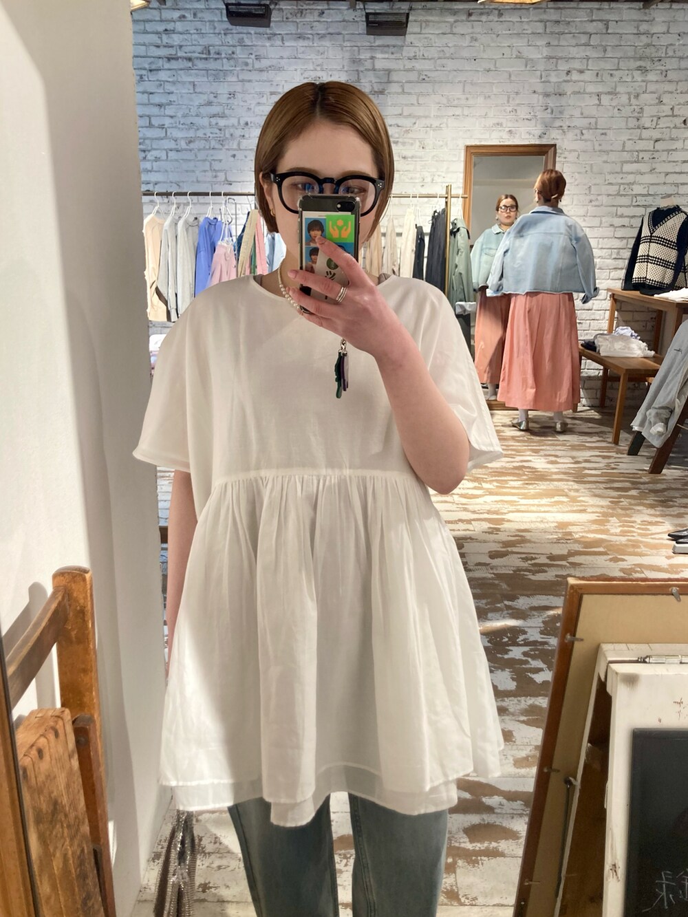 ブルー系のデニムパンツ、ゴールド系のショルダーバッグ、ブルー系のデニムパンツを着用したレディースの春コーディネートの5枚目の写真