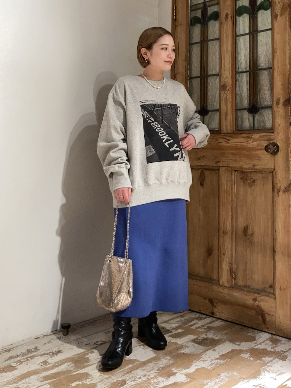 ブラック系のブーツ、ブルー系のスカート、ブルー系のスカートを着用したレディースの冬コーディネートの2枚目の写真