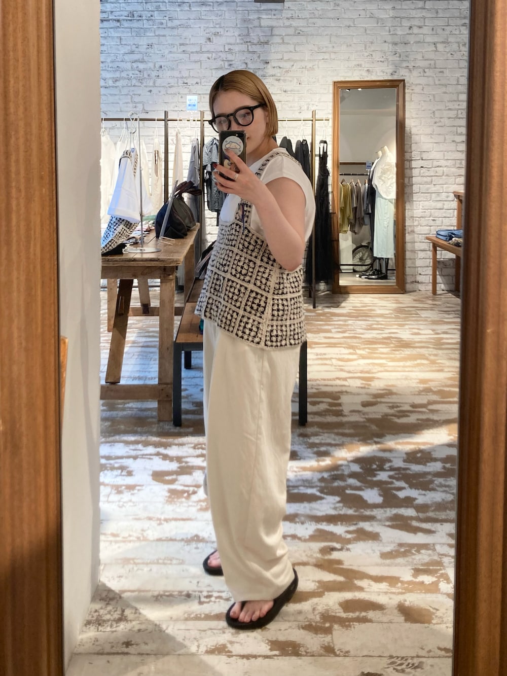 ゴールド系のショルダーバッグ、ブラック系のサンダル、その他のベストを着用したレディースの夏コーディネートの5枚目の写真