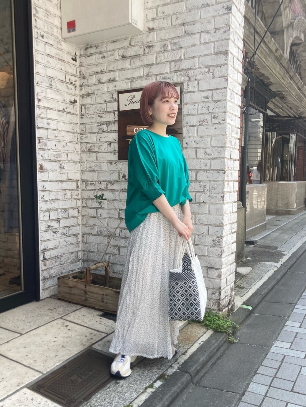 グリーン系のTシャツ/カットソー、ホワイト系のスカート、グリーン系のカーディガン/ボレロを着用したレディースの夏コーディネートの3枚目の写真