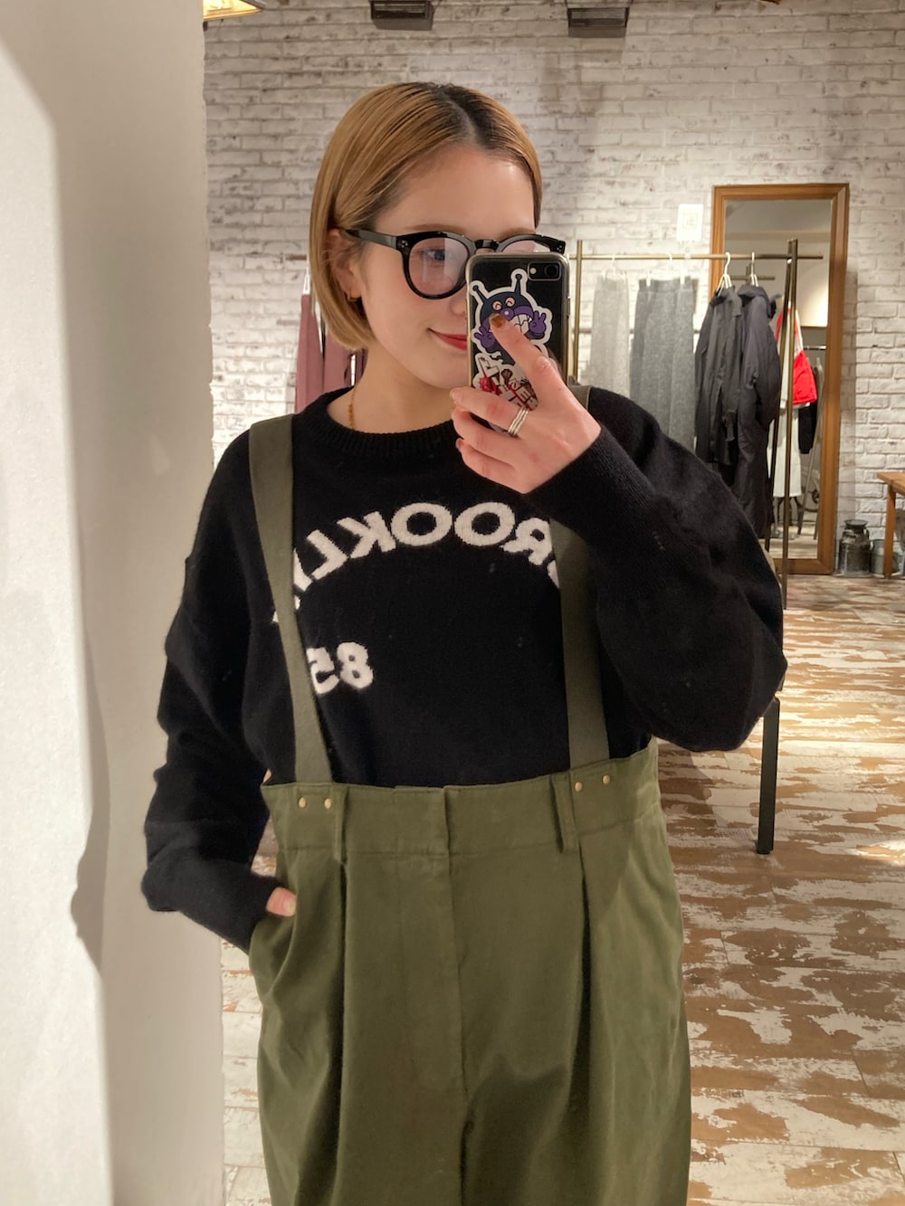 グリーン系のカーゴパンツ、ブラック系のニット/セーターを着用したレディースの冬コーディネートの3枚目の写真