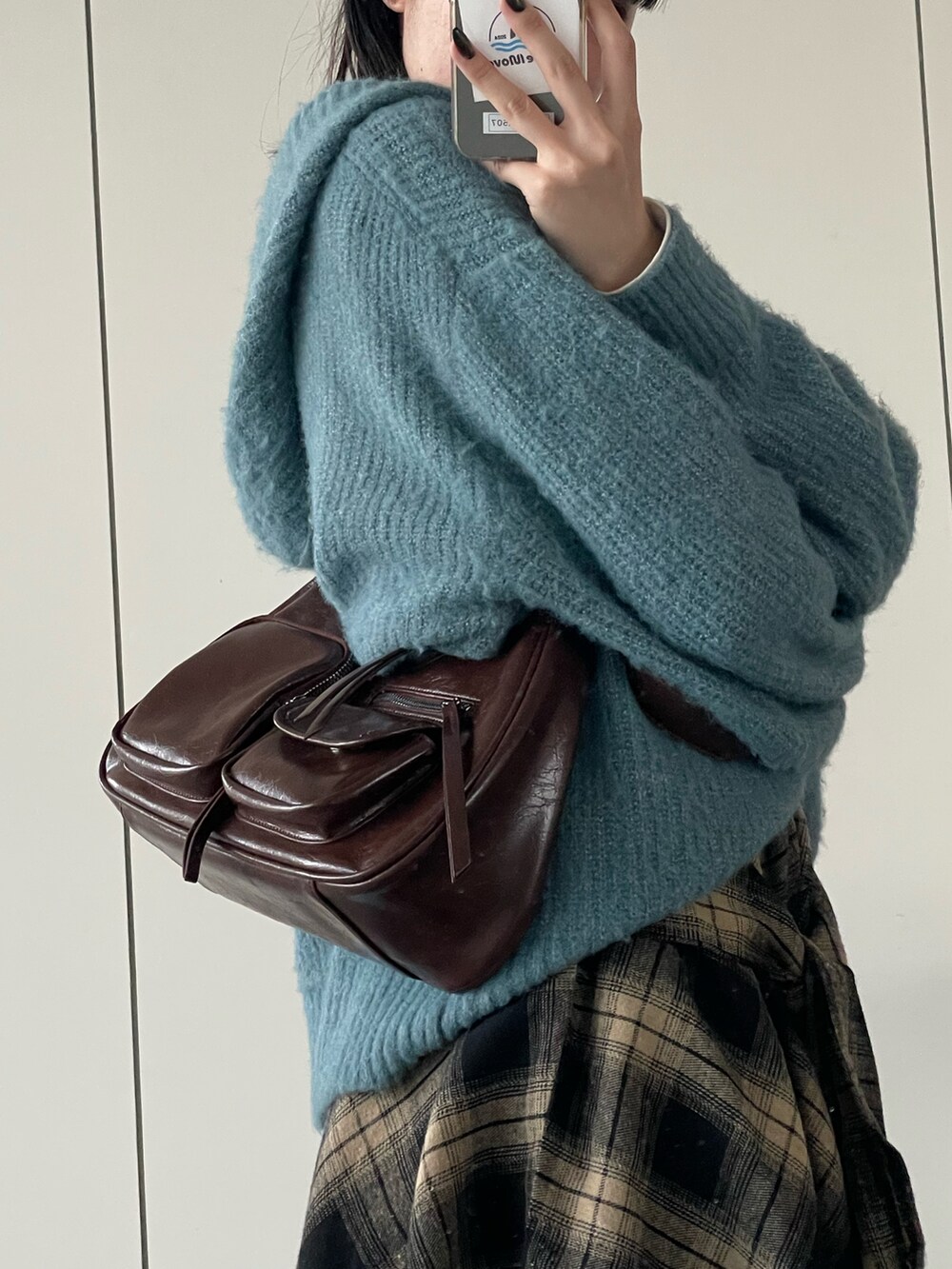 ブルー系のニット/セーター、ブラウン系のショルダーバッグを着用したレディースの秋コーディネートの5枚目の写真