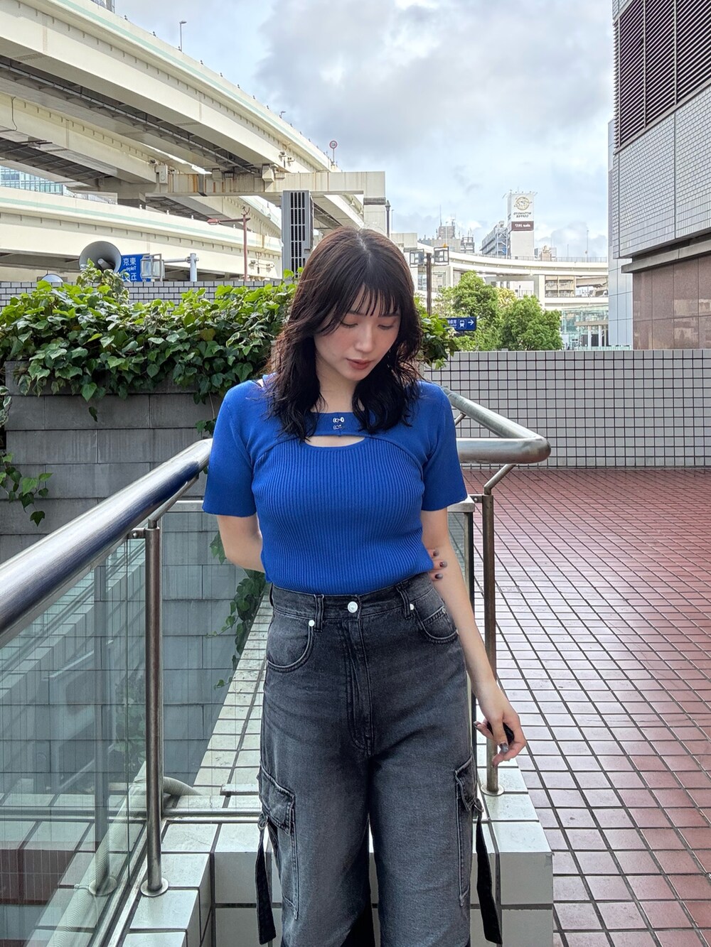 ブルー系のニット/セーター、ブラック系のデニムパンツを着用したレディースの夏コーディネートの2枚目の写真