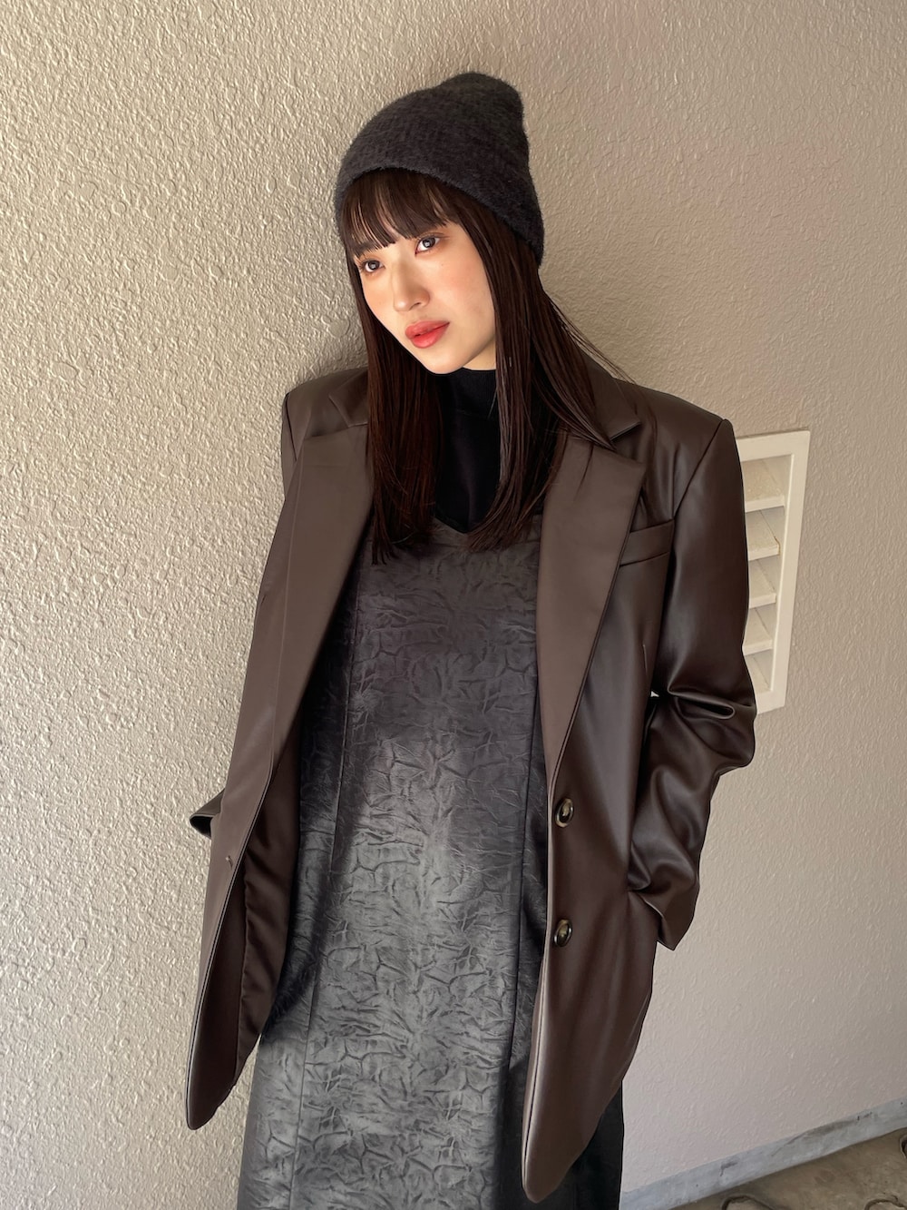 ブラック系のワンピース、ブラウン系のテーラードジャケットを着用したレディースの夏コーディネートの3枚目の写真