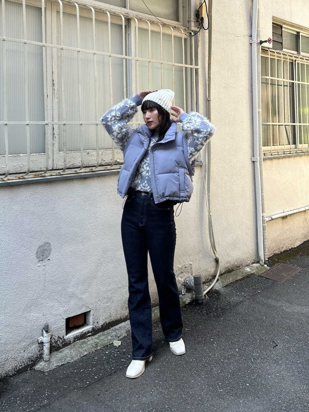 パープル系のニット/セーター、ブルー系のブルゾン、ブルー系のデニムパンツを着用したレディースの秋コーディネートの5枚目の写真