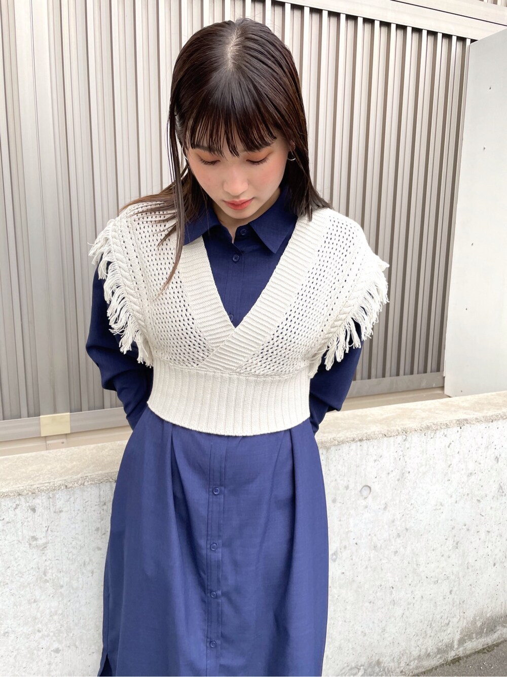 ブルー系のシャツ/ブラウス、ホワイト系のサンダル、グレー系のニット/セーターを着用したレディースの春コーディネートの7枚目の写真