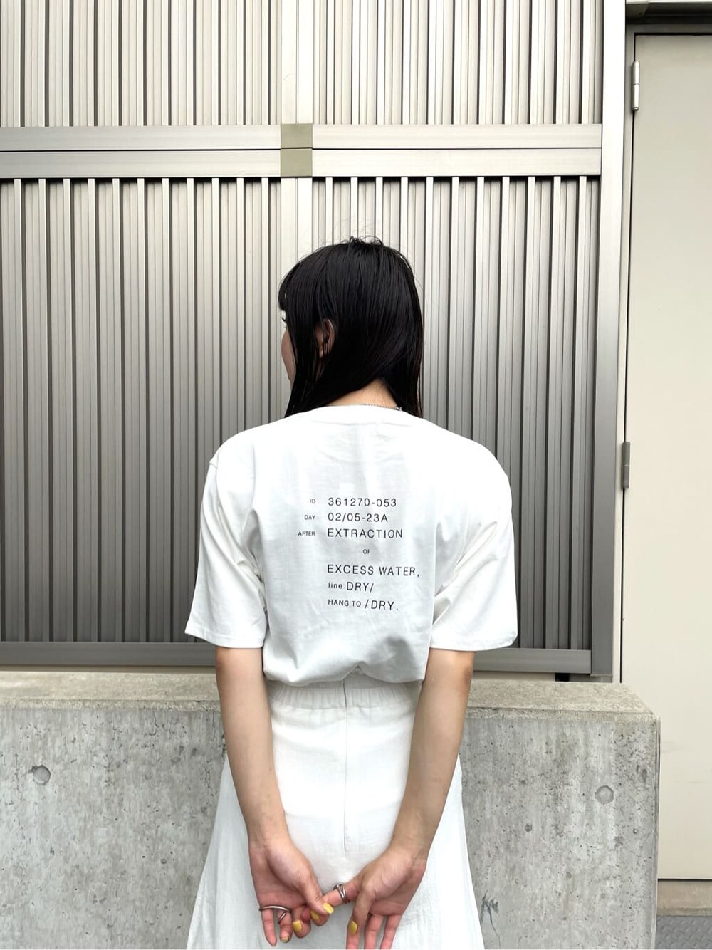 ホワイト系のスカート、ホワイト系のサンダル、ホワイト系のTシャツ/カットソーを着用したレディースの夏コーディネートの6枚目の写真