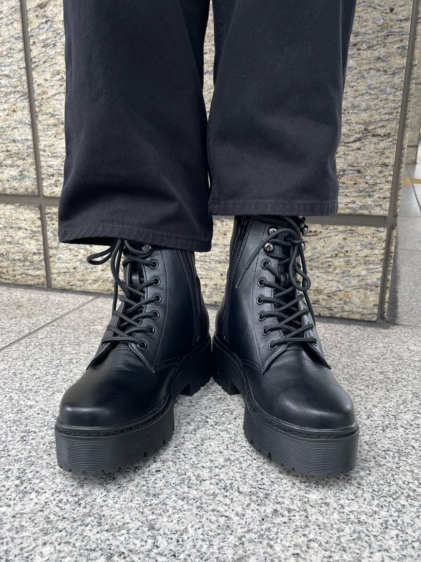 ブラック系のブーツ、ブラック系のデニムパンツ、ブラック系のタンクトップを着用したレディースの春コーディネートの8枚目の写真