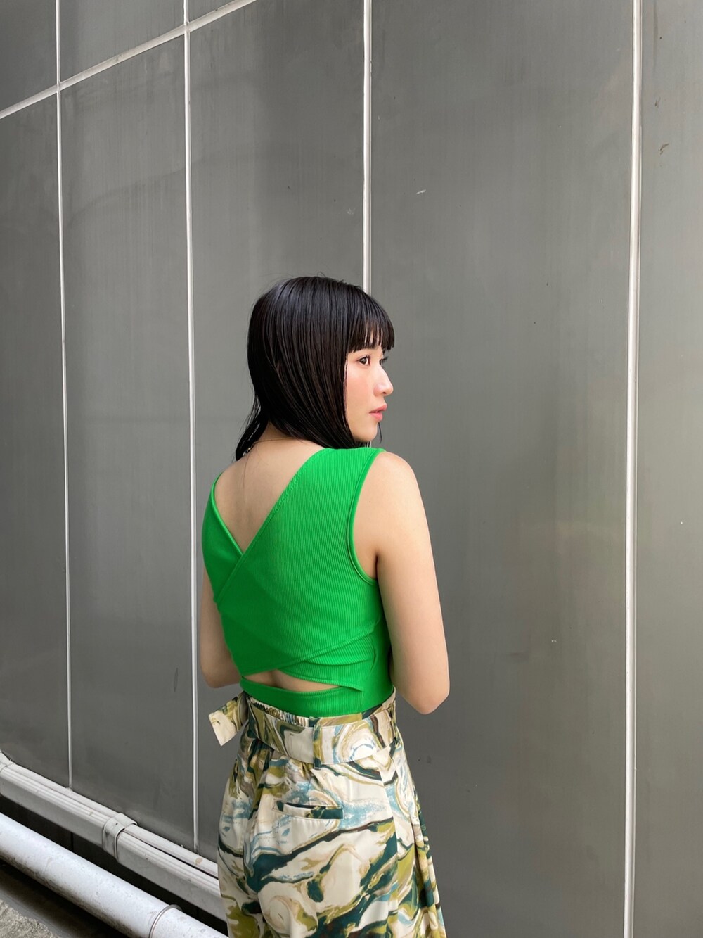 ブラック系のサンダル、グリーン系のスラックス、グリーン系のタンクトップを着用したレディースの春コーディネートの4枚目の写真