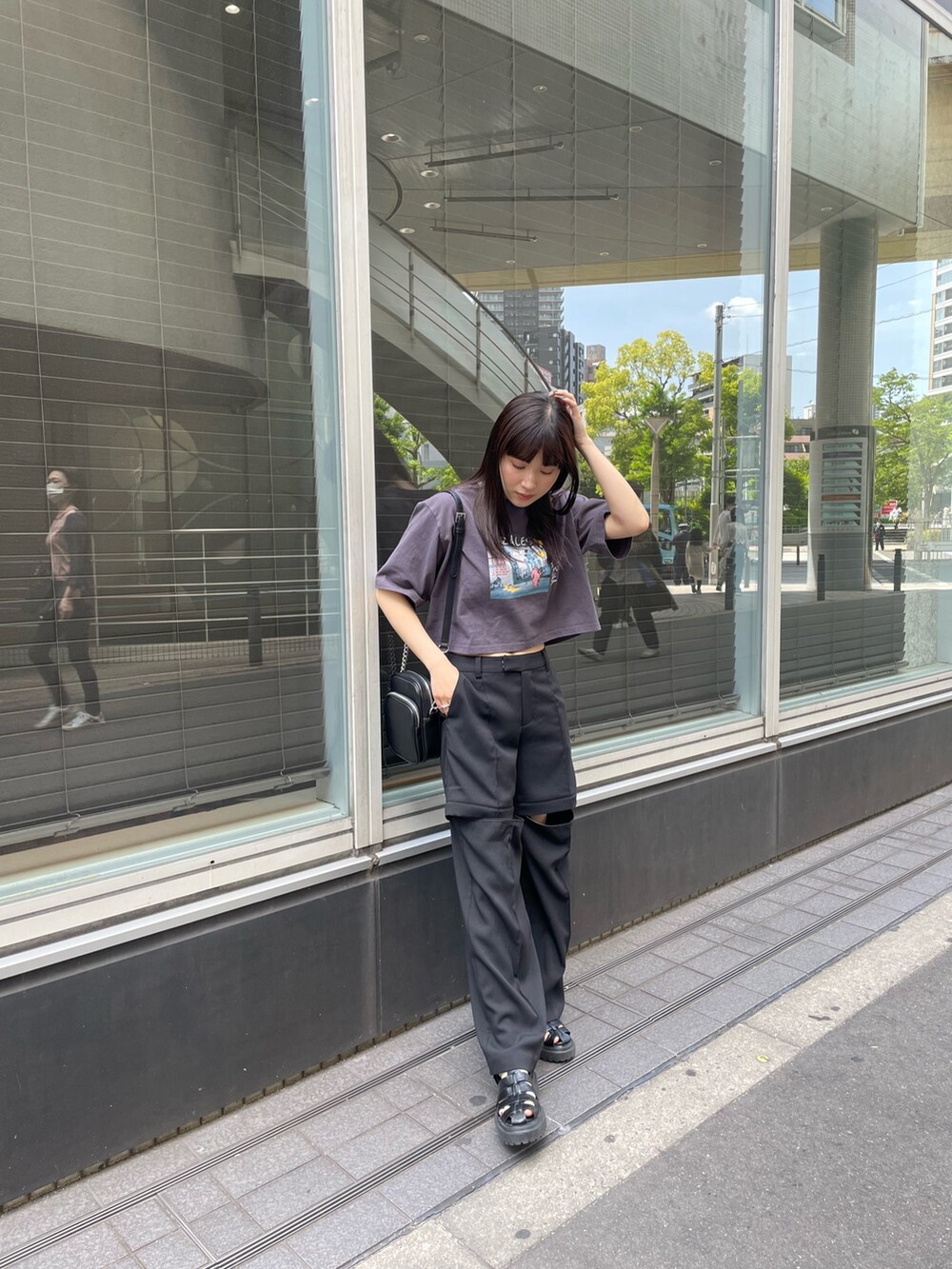 ブラック系のスラックス、ホワイト系のTシャツ/カットソーを着用したレディースの春コーディネートの4枚目の写真