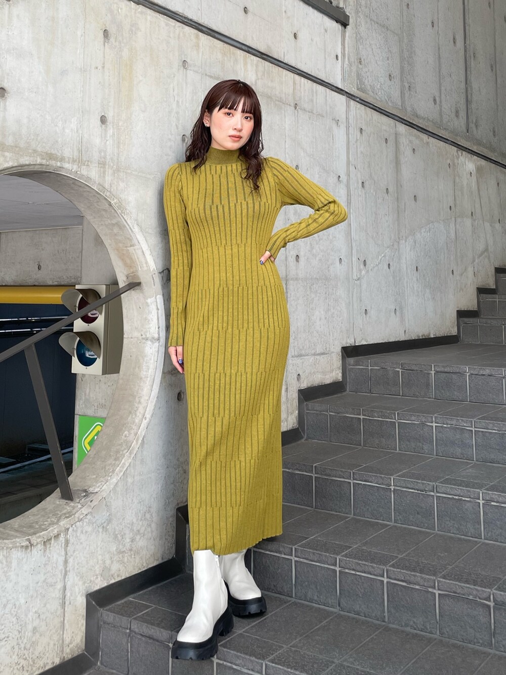 グレー系のムートンコート、イエロー系のワンピースを着用したレディースの秋コーディネートの4枚目の写真