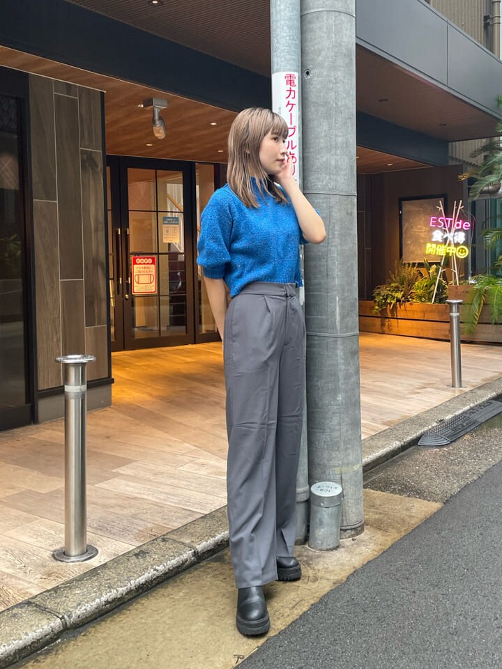 ブルー系のニット/セーター、ブルー系のトレンチコート、グレー系のスラックスを着用したレディースの秋コーディネートの3枚目の写真