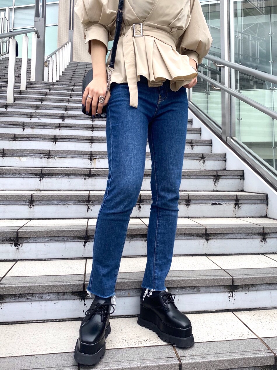 ベージュ系のシャツ/ブラウス、ブルー系のデニムパンツ、ブラック系のハンドバッグを着用したレディースの春コーディネートの6枚目の写真