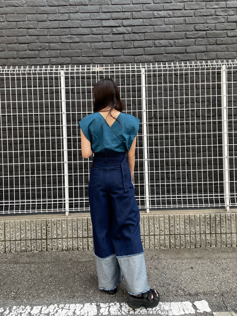 ブルー系のデニムパンツ、ブラック系のサンダル、ブルー系のシャツ/ブラウスを着用したレディースの春コーディネートの2枚目の写真