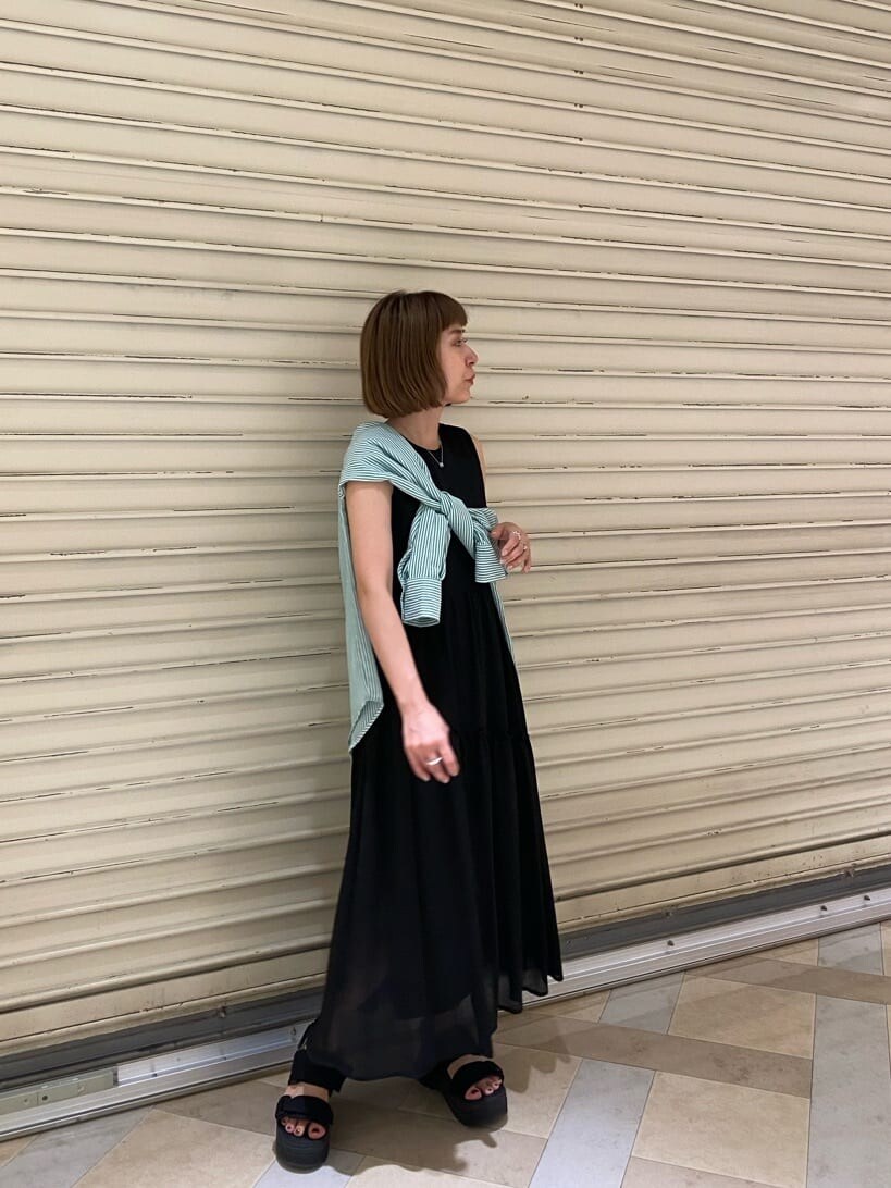 ブラック系のサンダル、ブラック系のワンピース、グリーン系のシャツ/ブラウスを着用したレディースの夏コーディネートの2枚目の写真