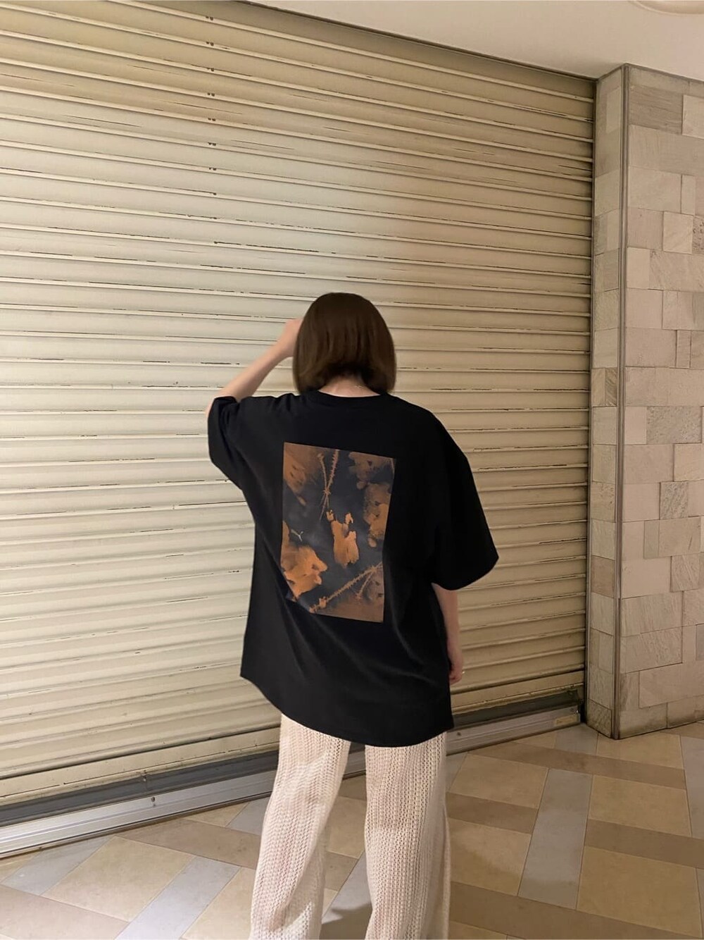 ブラック系のサンダル、ブラック系のTシャツ/カットソー、ホワイト系のスウェットパンツを着用したレディースの春コーディネートの4枚目の写真