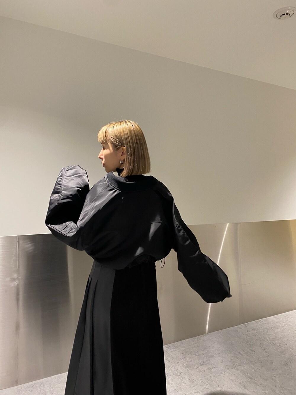 ブラック系のMA-1、ブラック系のワンピース、ブラック系のローファーを着用したレディースの冬コーディネートの4枚目の写真