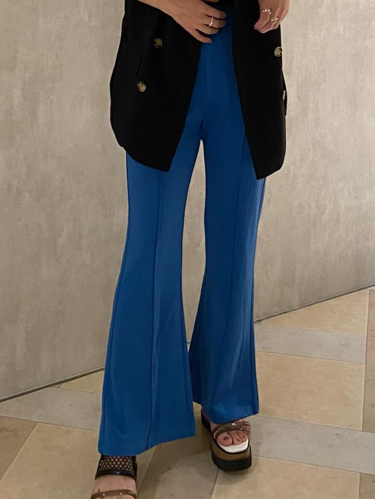 ブルー系のスラックス、ブラック系のベスト、ブラック系のタンクトップを着用したレディースの夏コーディネートの6枚目の写真