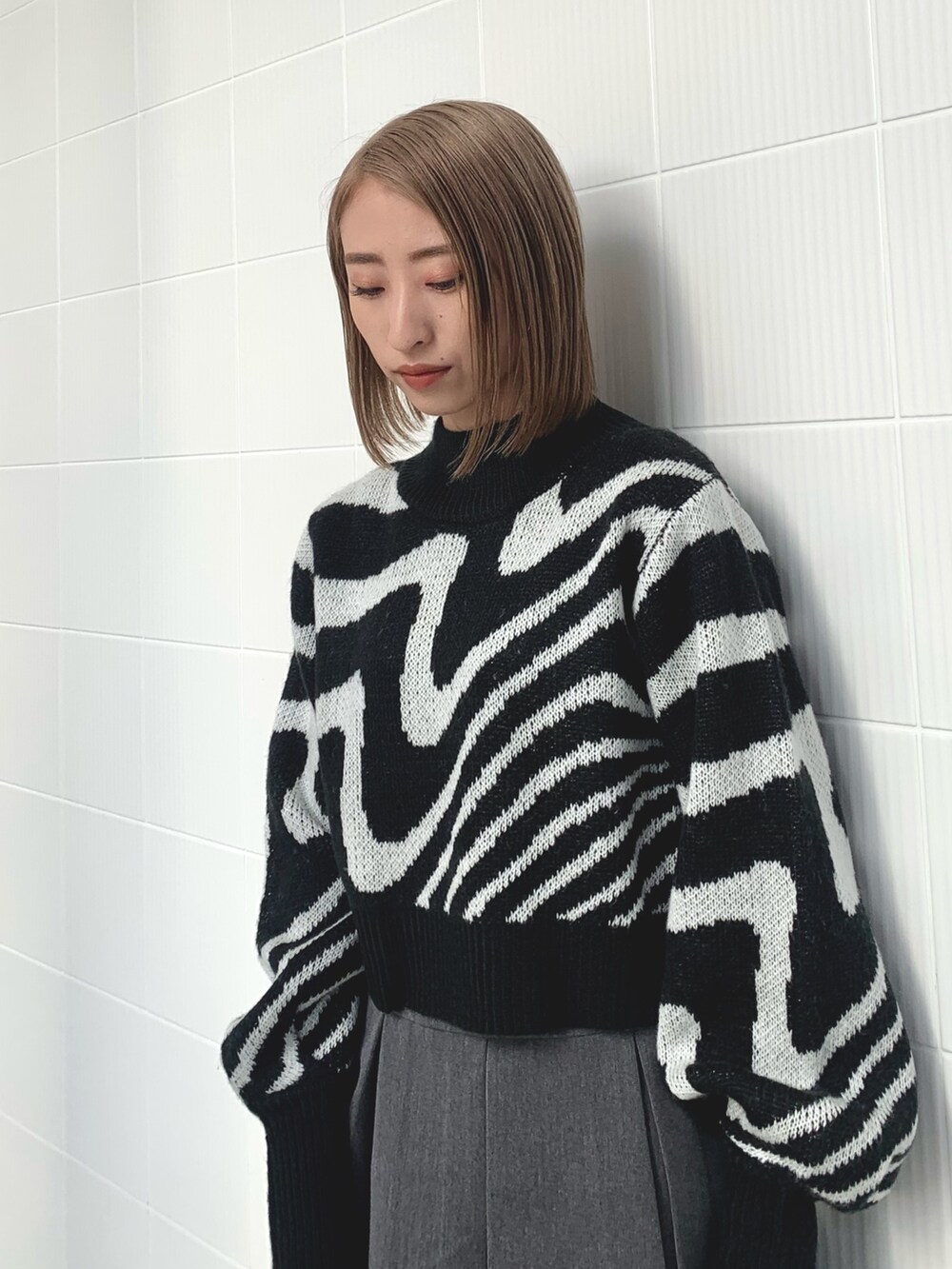 ブラック系のニット/セーター、ブラック系のブルゾン、ブラック系のブーツを着用したレディースの冬コーディネートの7枚目の写真