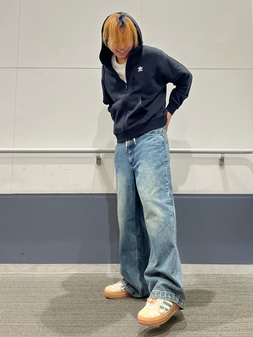 ベージュ系のスニーカー、ブラック系のパーカーを着用したメンズの秋コーディネートの2枚目の写真