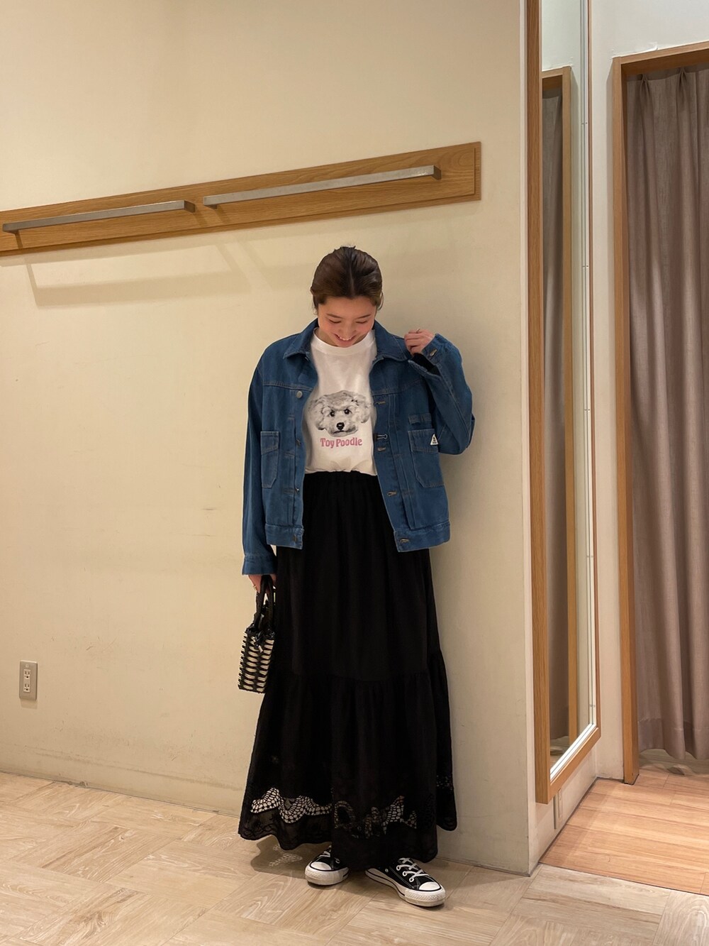 ブルー系のデニムジャケット、ホワイト系のTシャツ/カットソー、ブラック系のショルダーバッグを着用したレディースの春コーディネートの2枚目の写真