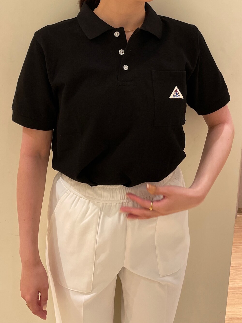 ブラック系のTシャツ/カットソー、ホワイト系のスラックスを着用したレディースの夏コーディネートの3枚目の写真