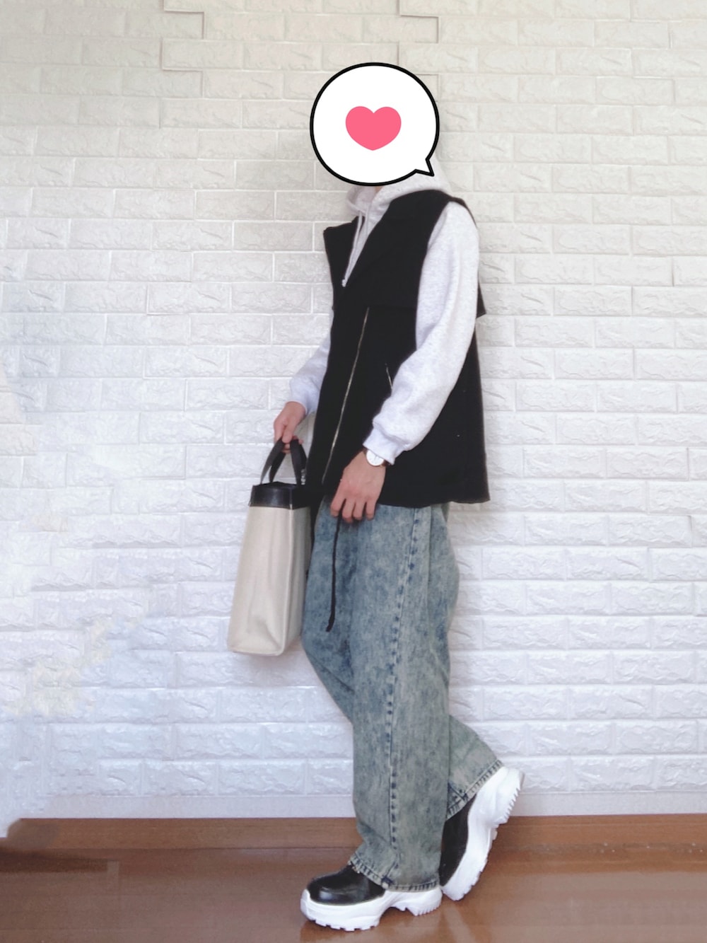 グレー系のパーカー、ブラック系のベスト、ベージュ系のトートバッグを着用したメンズの夏コーディネートの3枚目の写真