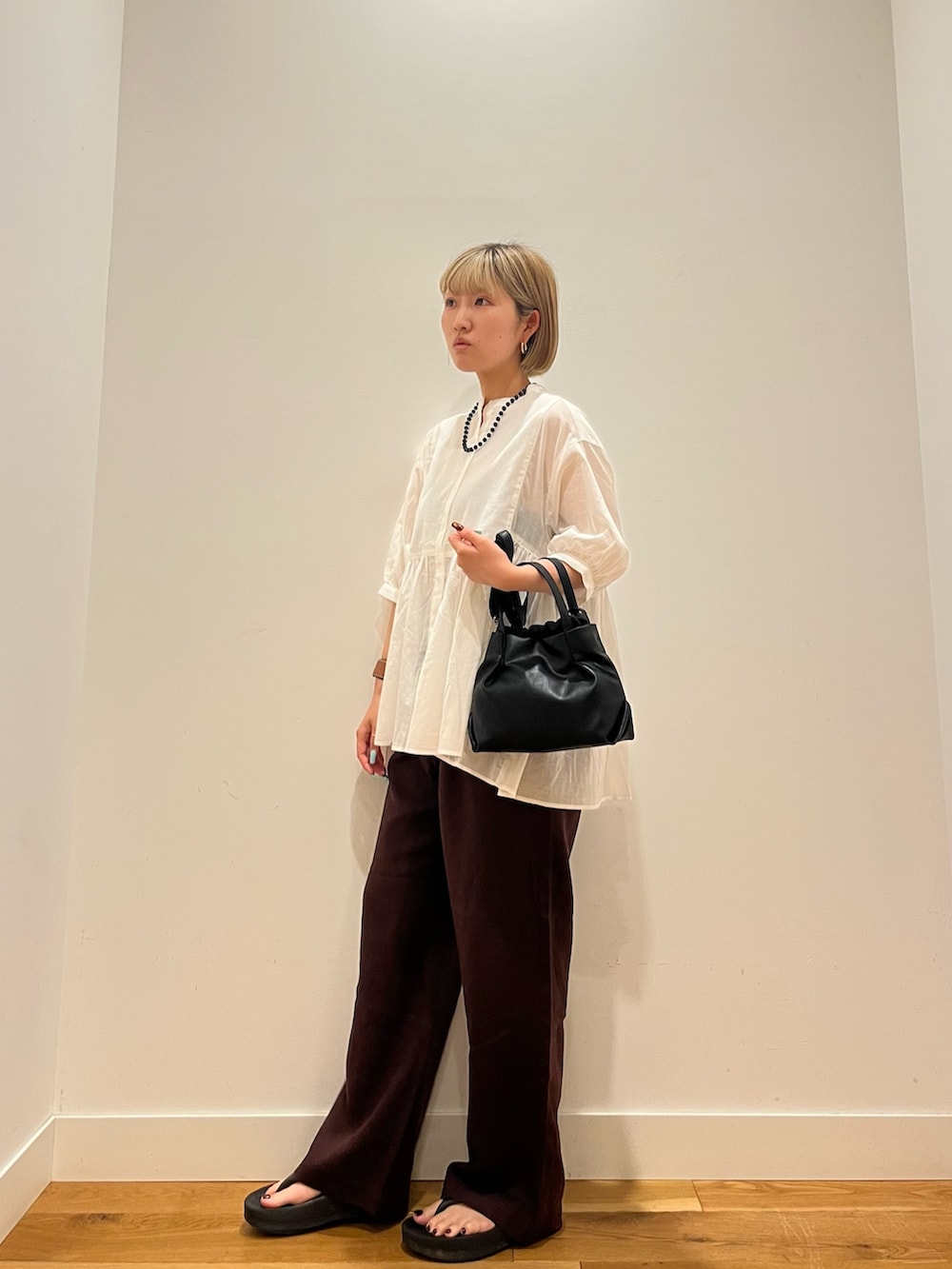 レッド系のその他パンツ、グレー系のシャツ/ブラウス、ブルー系のネックレスを着用したレディースの夏コーディネートの3枚目の写真