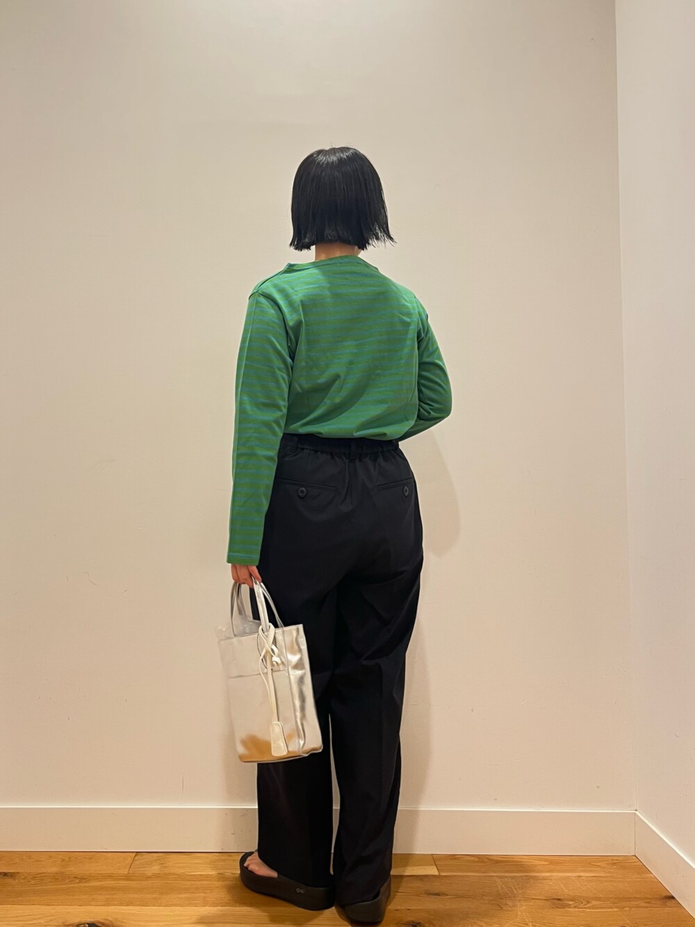 グリーン系のTシャツ/カットソー、ブルー系のその他パンツ、ブラック系のハンドバッグを着用したレディースの秋コーディネートの4枚目の写真