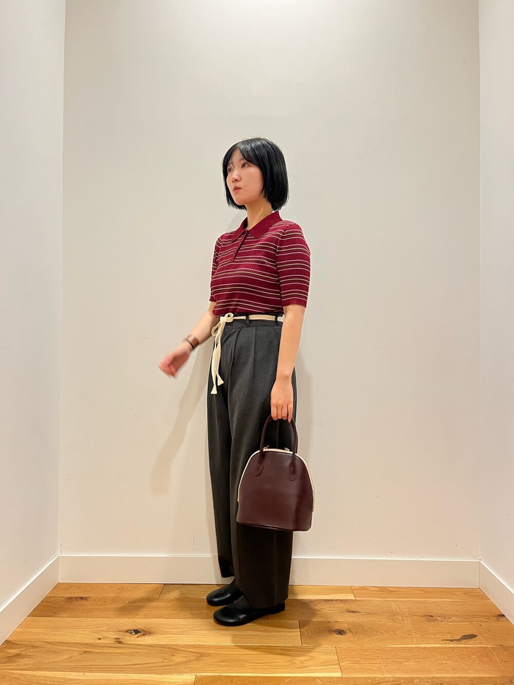 グレー系のその他パンツ、レッド系のハンドバッグ、ブラック系のその他シューズを着用したレディースの秋コーディネートの2枚目の写真