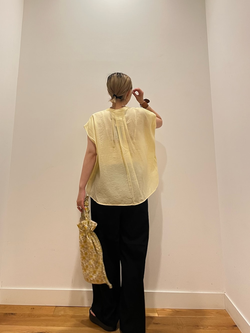 ブラック系のその他パンツ、イエロー系のシャツ/ブラウス、イエロー系のトートバッグを着用したレディースの夏コーディネートの3枚目の写真