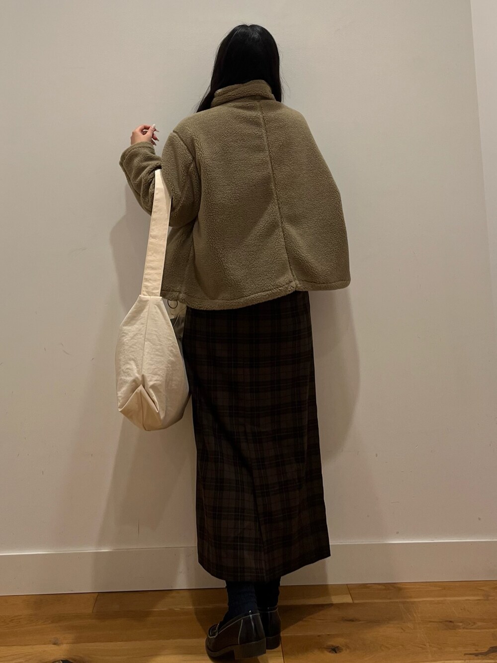 ホワイト系のショルダーバッグ、ベージュ系のブルゾン、ホワイト系のニット/セーターを着用したレディースの秋コーディネートの3枚目の写真