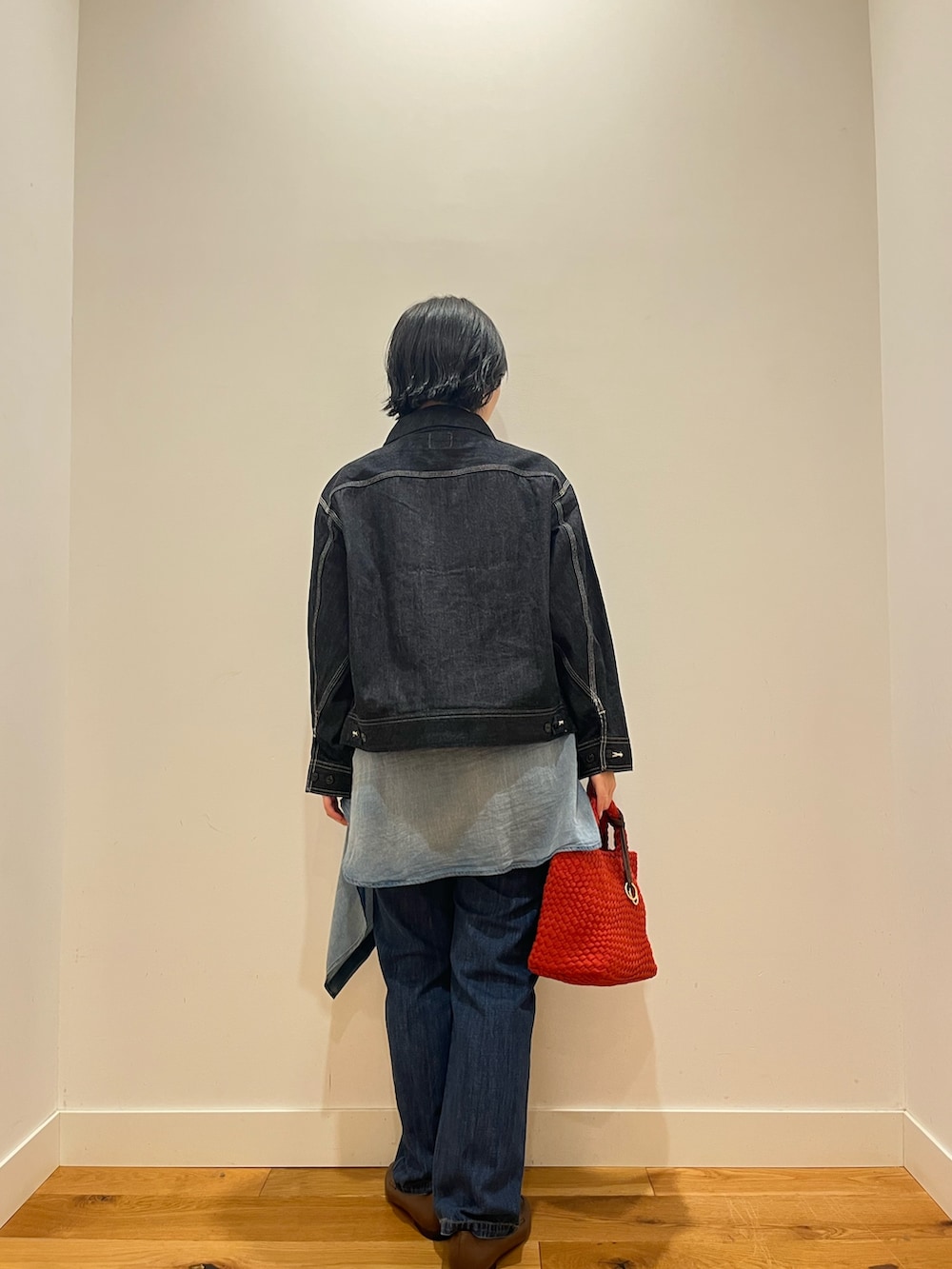 ブルー系のデニムパンツ、ブルー系のシャツ/ブラウス、ホワイト系のキャミソールを着用したレディースの秋コーディネートの3枚目の写真