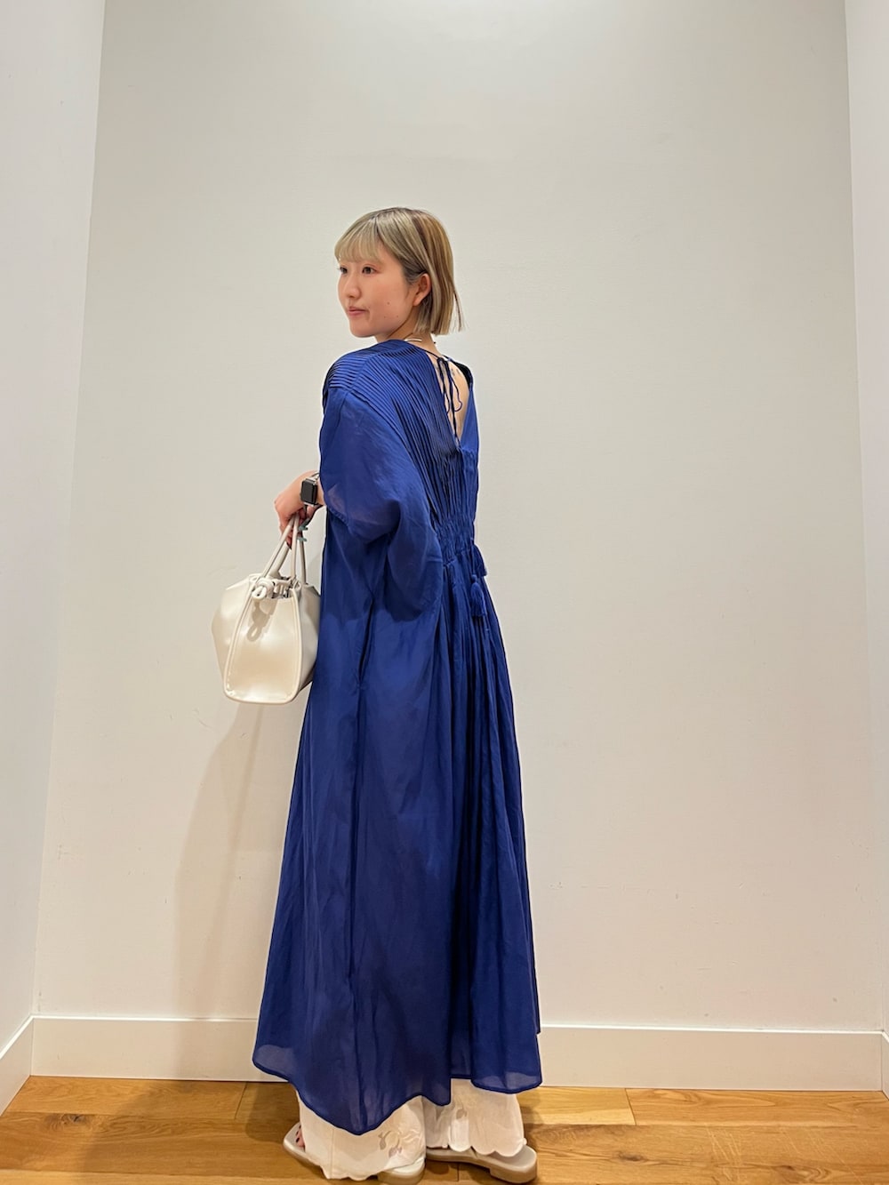 ホワイト系のトートバッグ、ブルー系のワンピース、ホワイト系のその他パンツを着用したレディースの春コーディネートの4枚目の写真