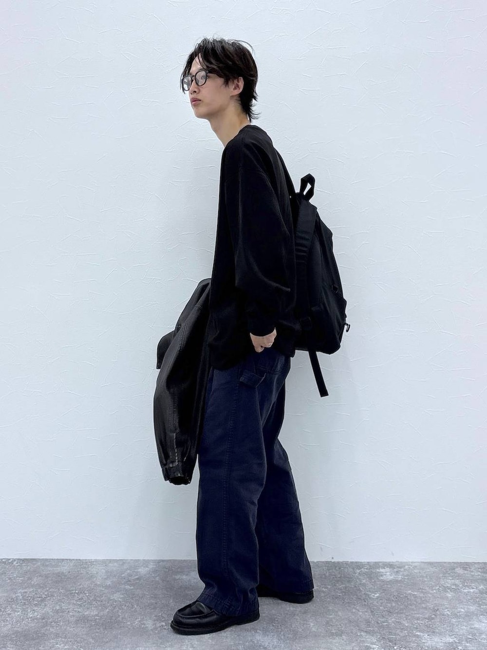 ブラック系のスウェット、ブラック系のブルゾン、ブラック系のバックパック/リュックを着用したメンズの秋コーディネートの4枚目の写真