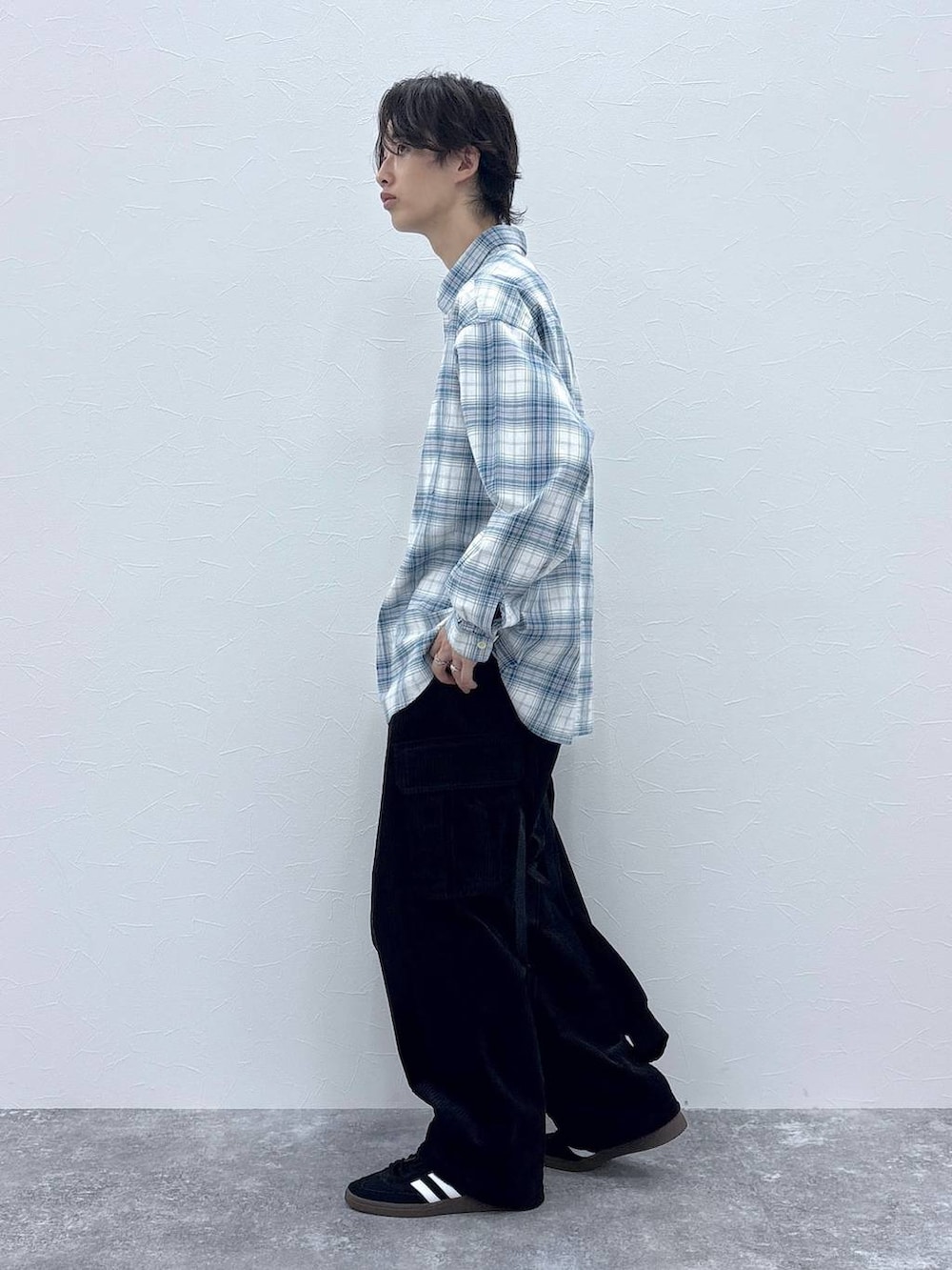 ブラック系のスニーカー、ブラック系のカーゴパンツ、ホワイト系のシャツ/ブラウスを着用したメンズの秋コーディネートの4枚目の写真