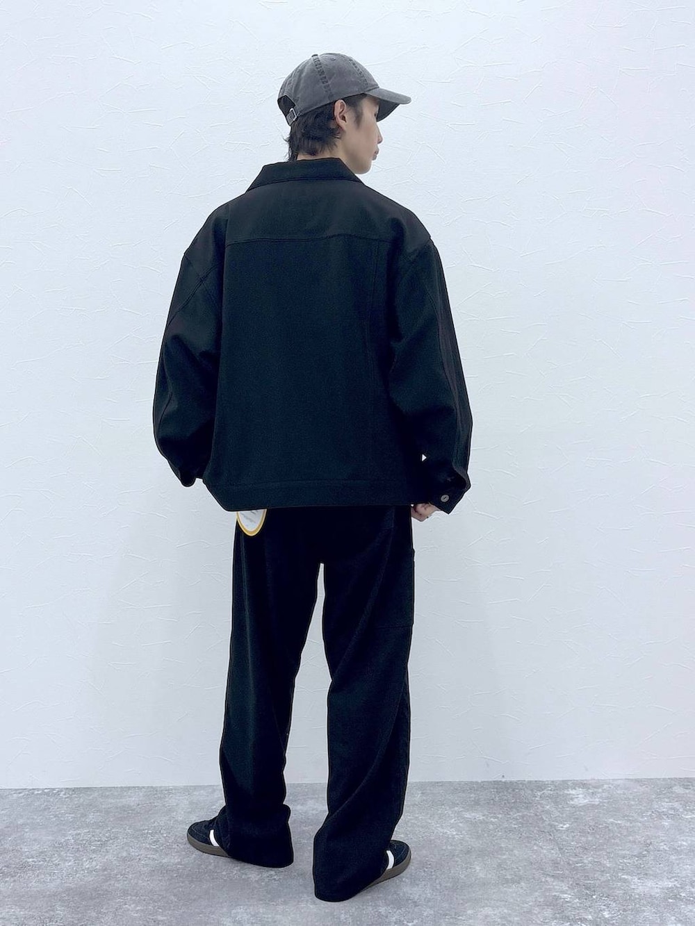 ブラック系のスニーカー、グレー系のTシャツ/カットソー、ブラック系のブルゾンを着用したメンズの秋コーディネートの9枚目の写真