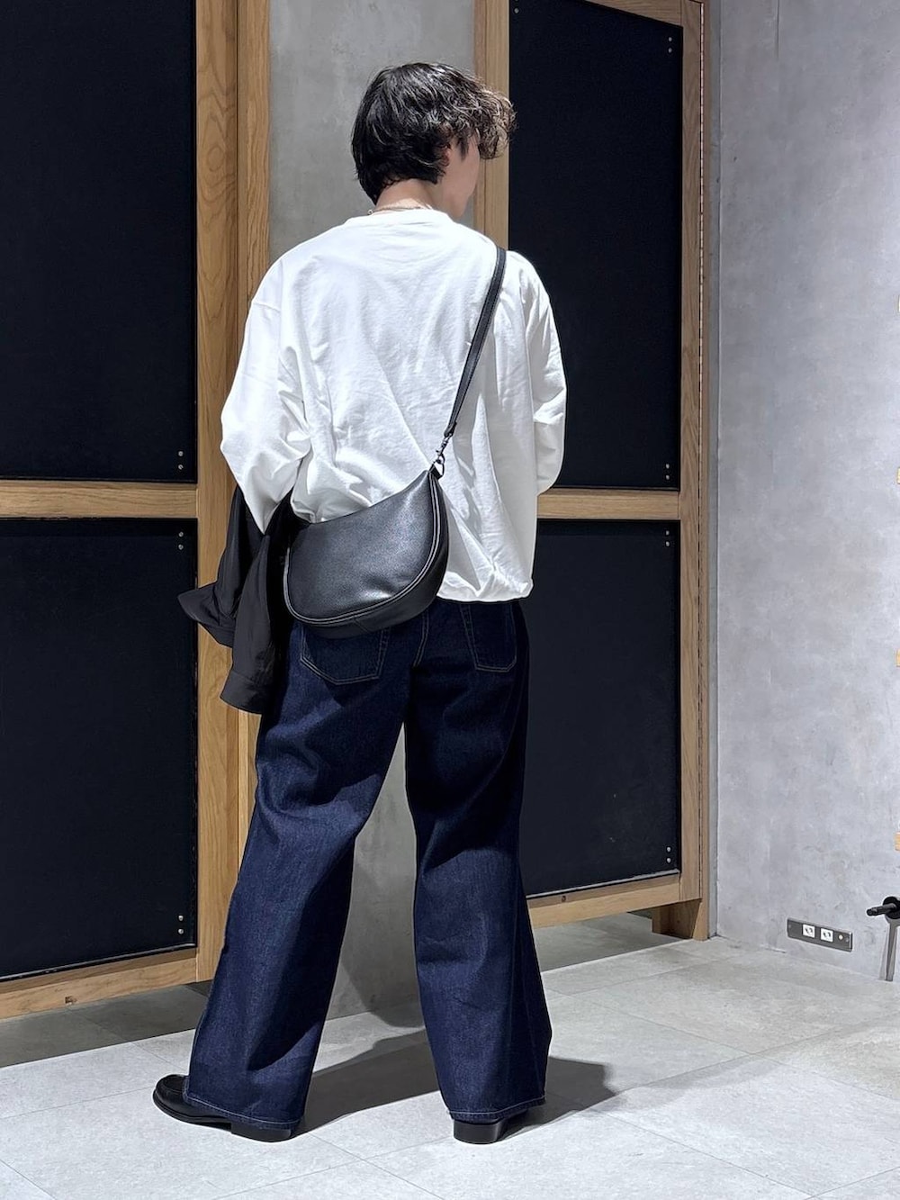 ブラック系のショルダーバッグ、ブラック系のブルゾン、ホワイト系のスウェットを着用したメンズの春コーディネートの5枚目の写真