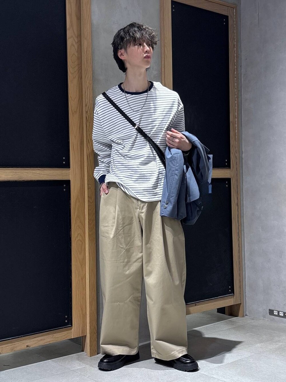 ブルー系のテーラードジャケット、ブラック系のドレスシューズ、ブラック系のショルダーバッグを着用したメンズの春コーディネートの6枚目の写真