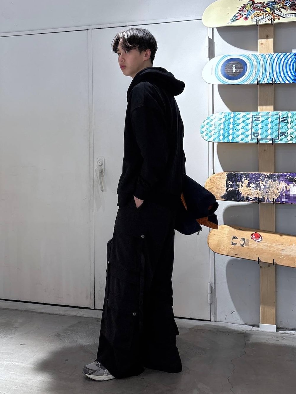 ホワイト系のTシャツ/カットソー、ブラック系のカーゴパンツ、ブルー系のMA-1を着用したメンズの春コーディネートの4枚目の写真