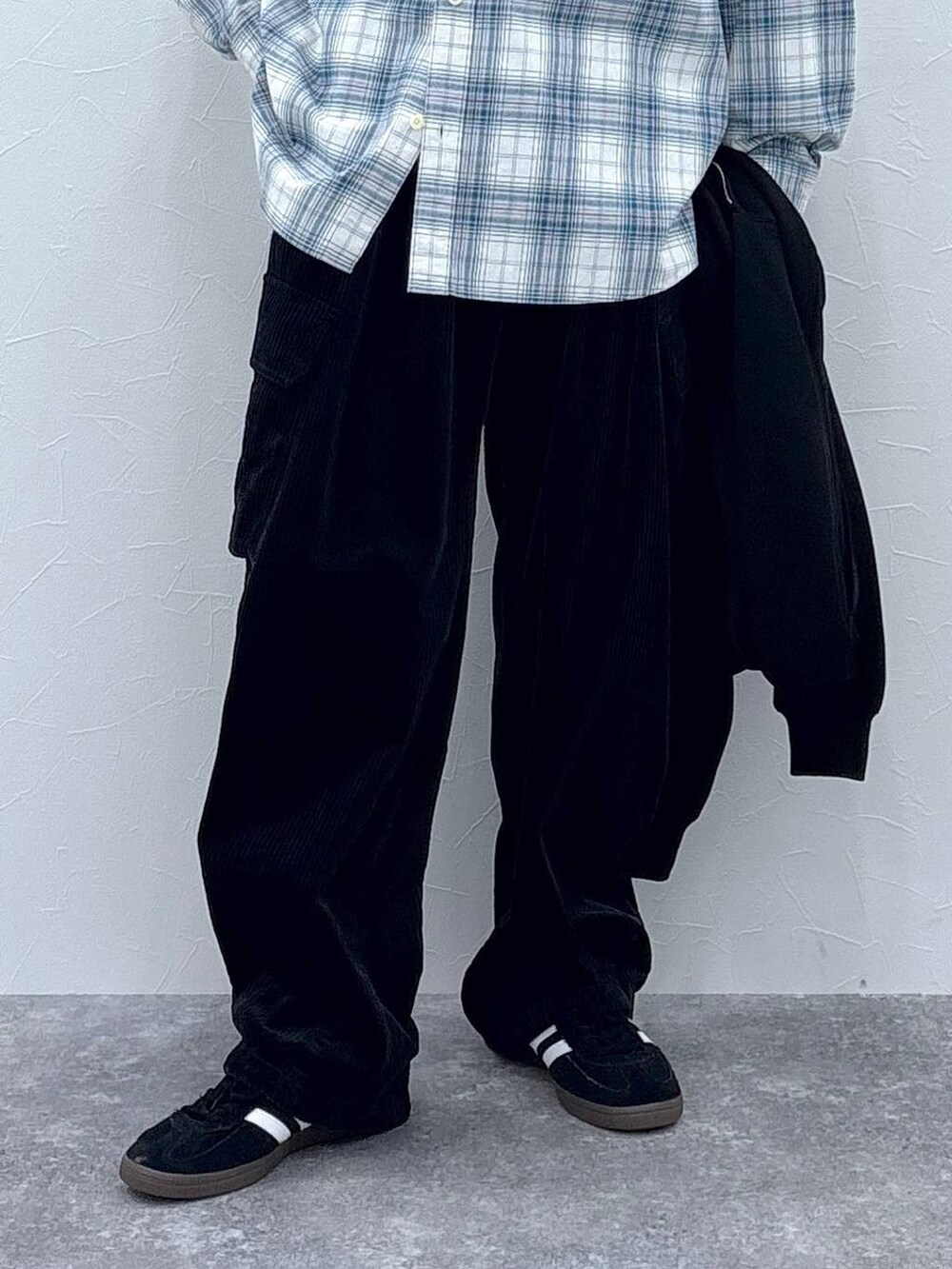 ブラック系のスニーカー、ブラック系のカーゴパンツ、ホワイト系のシャツ/ブラウスを着用したメンズの秋コーディネートの3枚目の写真