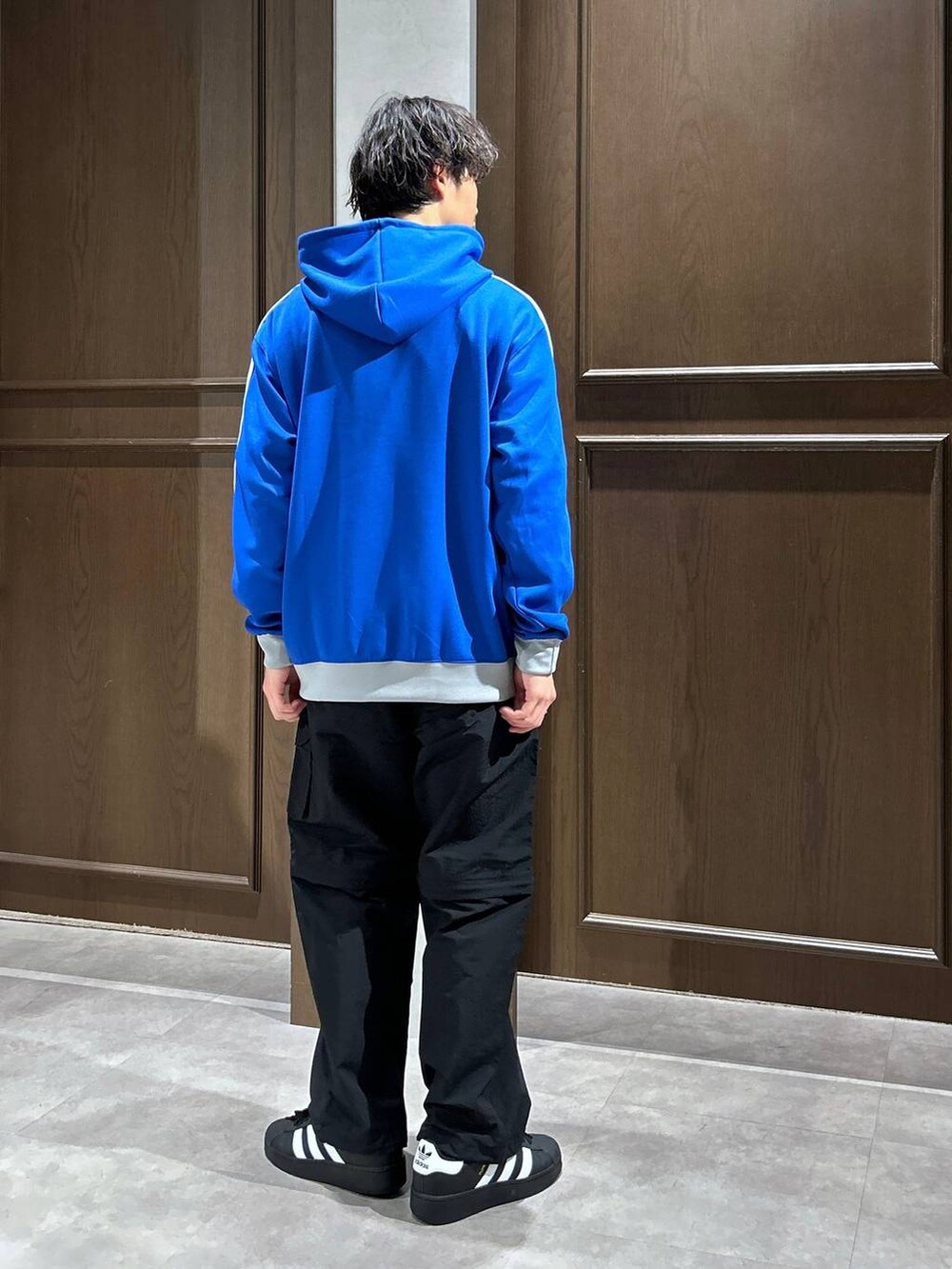 ホワイト系のTシャツ/カットソー、ブルー系のパーカー、ブラック系のカーゴパンツを着用したメンズの春コーディネートの4枚目の写真
