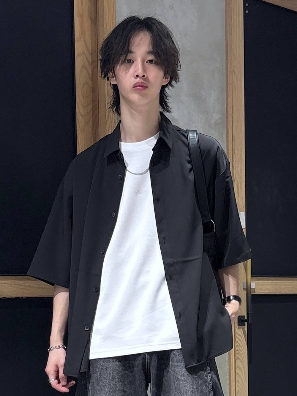ブラック系のシャツ/ブラウス、ブラック系のショルダーバッグ、ホワイト系のTシャツ/カットソーを着用したメンズの春コーディネートの2枚目の写真