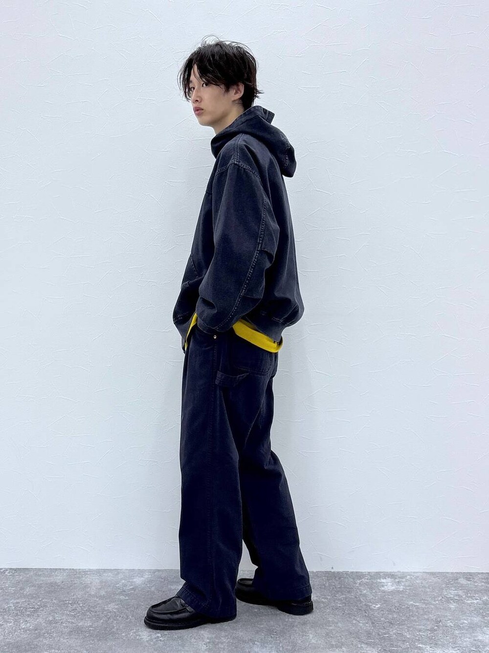 ブルー系のブルゾン、ブルー系のデニムパンツ、イエロー系のTシャツ/カットソーを着用したメンズの秋コーディネートの8枚目の写真