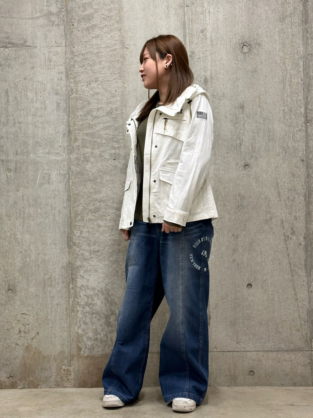 ブルー系のデニムパンツ、ホワイト系のその他アウター、グリーン系のTシャツ/カットソーを着用したレディースの冬コーディネートの2枚目の写真